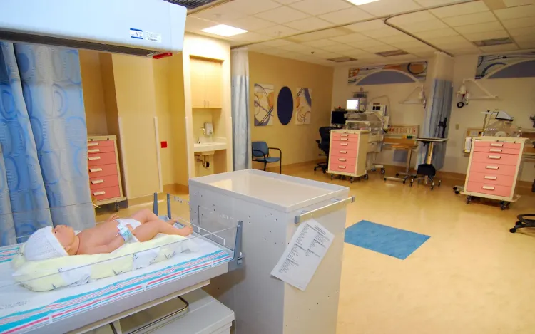 A hospital newborn care room with an infant warmer and incubators, for hospital and medical equipment suppliers