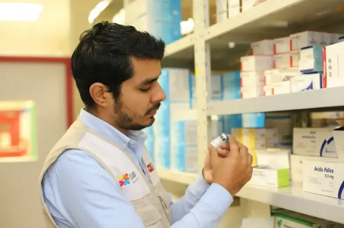 Shop owner holding a small product, for retail chains, pharmacies and corporate gifting