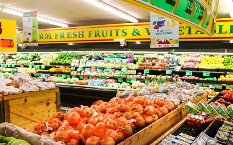 Fresh fruit and vegetable section of a grocery store with tomatoes in crates, for retail and supermarket chains