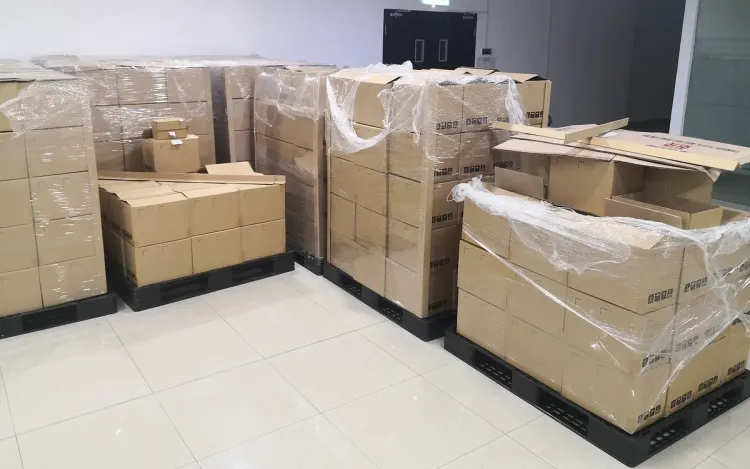 Cartons stacked on pallets in a distributor’s warehouse, for scale dealers and distributors