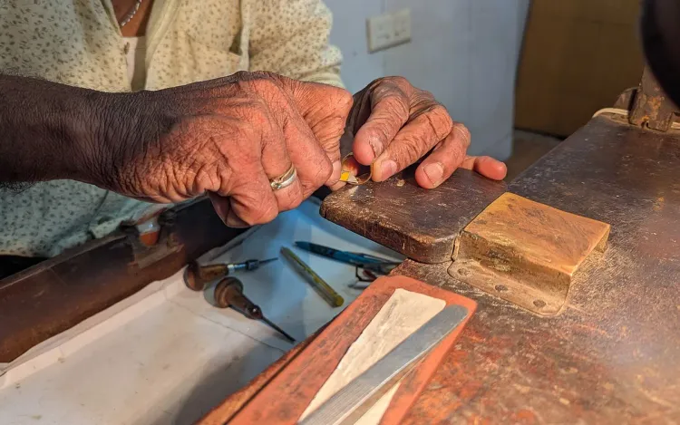 A goldsmith’s hands working on a gold ring at the bench, for gold loan and finance companies