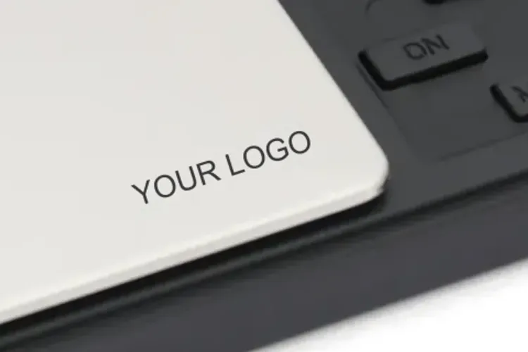 Your logo on the pocket scale pan Close-up of a pocket scale steel pan with YOUR LOGO printed on it, next to the keys